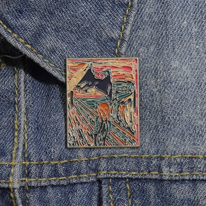 Artistic Van Gogh inspired enamel pin with The Scream motif on blue denim jacket collar