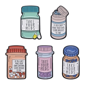 Five creative cartoon enamel pins featuring colorful medicine bottles and mental health quotes