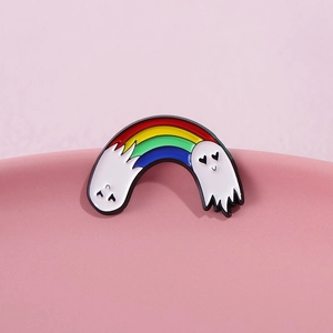 Cute rainbow ghost enamel pin brooch with heart eyes on a soft pink surface
