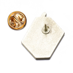 Macro view of the golden metal alloy brooch back with a secure butterfly clutch pin