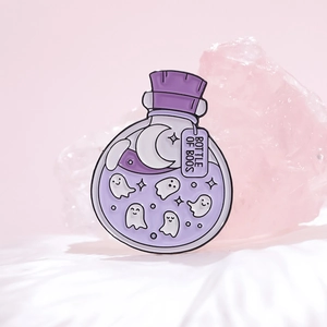 Detail of Bottle of Boos enamel pin with cute ghosts and crescent moon design