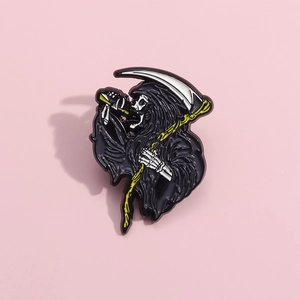 Gothic Grim Reaper enamel brooch with scythe and skull on light pink background