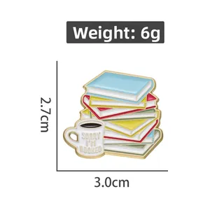 Detailed view of enamel pin with colorful books and coffee cup featuring dimensions