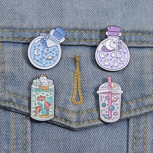Creative enamel pin set featuring ghost, starry bottle, and cat designs on denim jacket