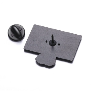 Macro detail of matte black enamel pin back with secure rubber butterfly clutch
