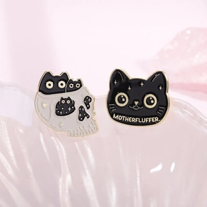 Creative black cat and skull enamel pin set with Motherfluffer text on pink background