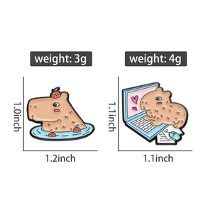 Detail view of cute capybara enamel pins with orange bath and computer work designs