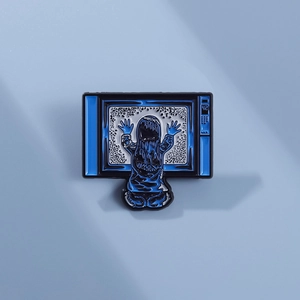 Geometric television brooch featuring a girl touching static screen with 42 detail