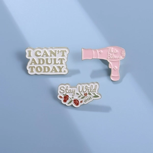 Creative enamel pin set featuring Stay Wild and I Can't Adult Today designs on blue background