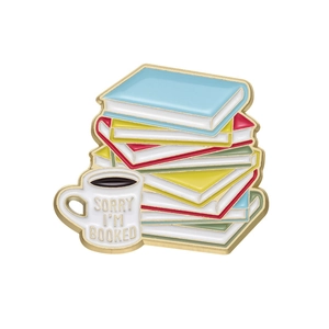 Artistic coffee and book stack enamel pin with Sorry I'm Booked gold plating