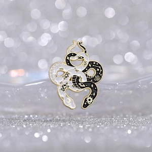 Creative black and white double snake enamel brooch with sun, moon, and lotus patterns