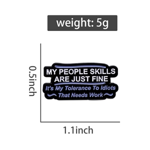 Detailed view of enamel banner pin with humorous text and dimensions in inches
