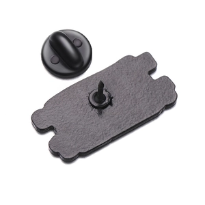 Detail view of the enamel pin back with textured metal finish and rubber clutch