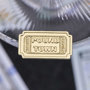 Creative golden ticket medal brooch with embossed Pound Town text in geometric metal