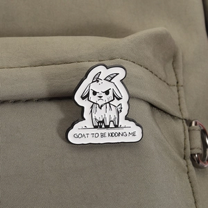Angry goat enamel pin badge with GOAT TO BE KIDDING ME text on dark green canvas bag