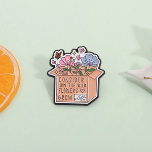 Wildflower box enamel brooch with Luke 12:27 quote on a natural pastel background