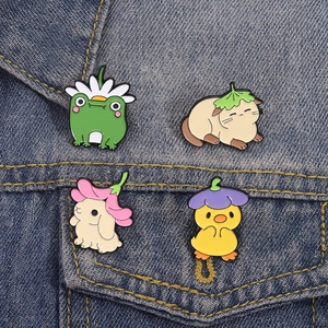Set of four cute cartoon animal enamel pins featuring frog, cat, rabbit and chick on denim