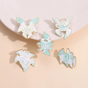 Five-piece set of white feather wing enamel pins with eye and heart motifs on gold metal