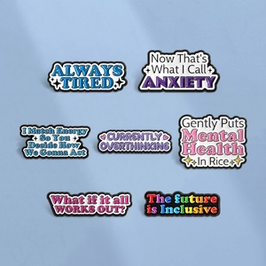 Set of 7 colorful enamel pins with fun emotional slogan text and bold artistic fonts
