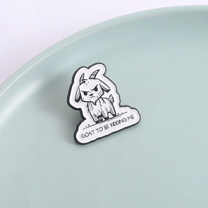 Funny cartoon goat enamel pin with GOAT TO BE KIDDING ME text on a ceramic dish