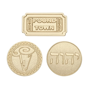 Three-piece golden metal pin set featuring ticket shapes and engraved medallions