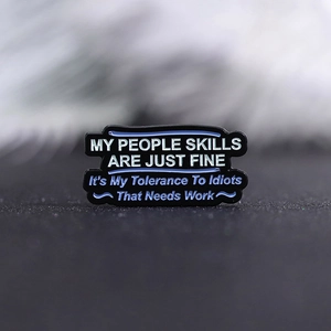 Funny black enamel quote brooch with witty typography and white text on a metal backing
