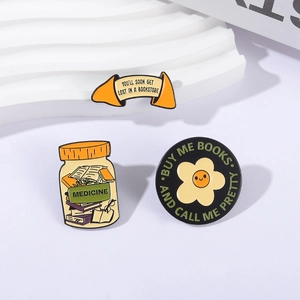 Three creative enamel pins featuring cartoon book jar and lucky cookie designs for book lovers