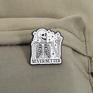 Macro shot of skull enamel pin with NEVER BETTER text on canvas fabric bag texture