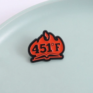 Fahrenheit 451 literary enamel pin featuring black and red burning book design