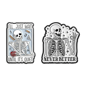Set of two cute skull enamel pins featuring school themes and OK hand gesture designs