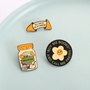 Three-piece bookworm enamel pin set featuring floral and medicine themes for readers