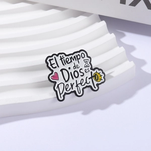 Enamel pin with Spanish phrase El tiempo de Dios es perfecto on white wavy stand