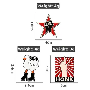 Detail view of cartoon enamel pins with SLAY and HONK text showing sizes and weights