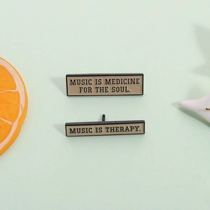 Black enamel rectangle pins featuring Music Is Medicine For The Soul and Music Is Therapy quotes