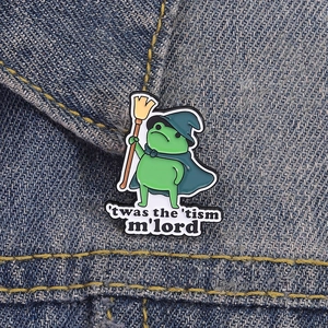 Wizard frog enamel pin with 'twas the 'tism quote on denim background