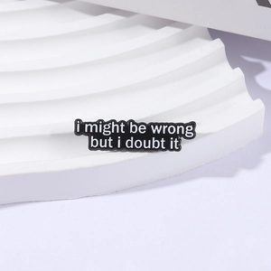 Minimalist black enamel brooch pin featuring white quote text I Might Be Wrong But I Doubt It