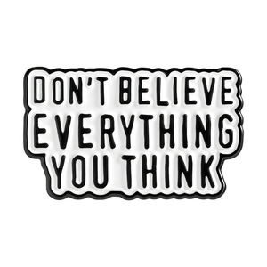 Enamel brooch with 'Don't Believe Everything You Think' quote on white background