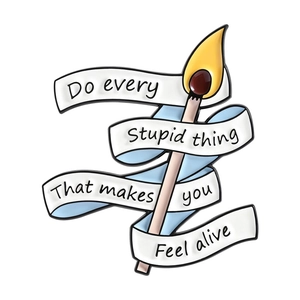 Creative matchstick enamel brooch with white ribbon and motivational quote on white backdrop