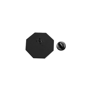 Detail view of the black octagonal badge back with secure pin and rubber clutch attachment