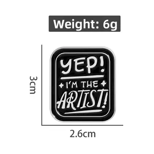Detail view of rectangular enamel pin with 'YEP! I'M THE ARTIST!' text measuring 3x2.6cm