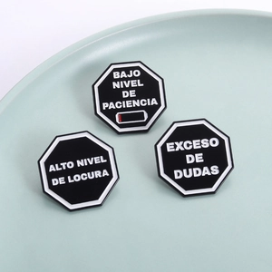 Three-piece set of octagonal enamel pins with humorous Spanish quotes on black background