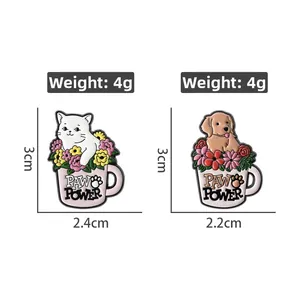 Detail view of Paw Power enamel pins showing cat and dog in flower cups with dimensions