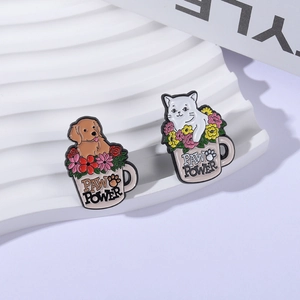 Cute enamel pins featuring a cat and a dog in flower mugs with Paw Power text