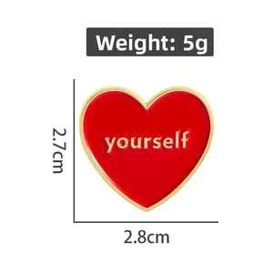 Detail of red heart enamel pin with gold yourself lettering and size specifications