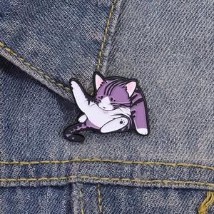 Funny purple cartoon cat enamel pin showing a cute kitty licking its belly on denim jacket