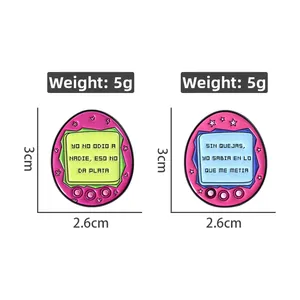 Detail showing pink retro electronic pet enamel pins with 3cm x 2.6cm dimensions