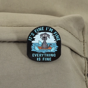 Close-up of enamel pin featuring a scared dog on a raft with sharks on khaki canvas fabric