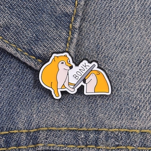 Funny Doge and Cheems Bonk meme enamel pin badge on blue denim fabric background