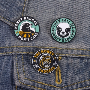 Lot de pin's émaillés blaireau avec slogan Don't Care sur tissu en jean bleu