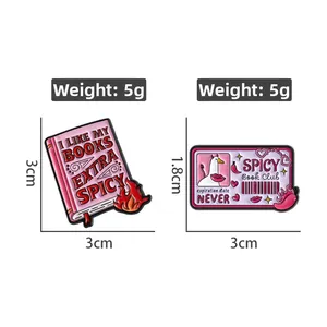 Detailed view of spicy book and duck club enamel pins with exact dimensions and weight